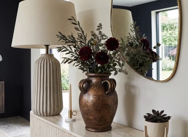 Curated ceramic tabletop vases in a warm Nordic interior